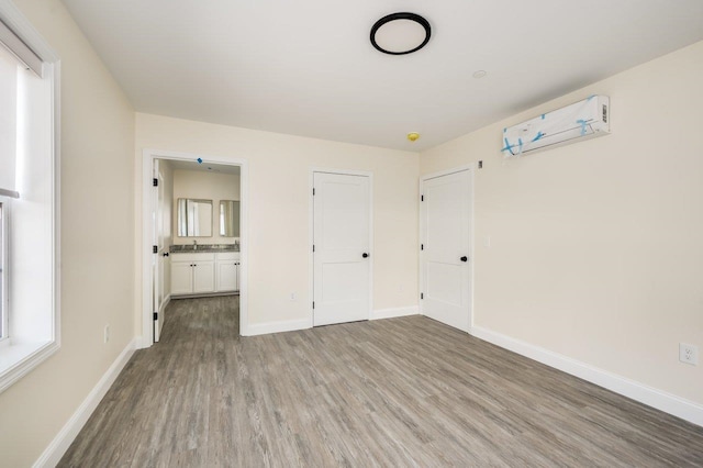 725 Central Ave Unit 103, Dover, NH 03820 - unfurnished bedroom with wood finished floors and ensuite bath