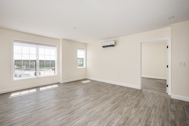 725 Central Ave Unit 103, Dover, NH 03820 - spare room featuring a wall mounted air conditioner and wood finished floors