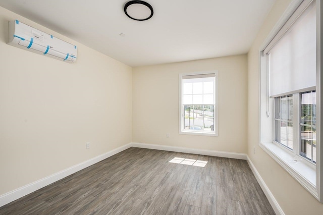 725 Central Ave Unit 103, Dover, NH 03820 - unfurnished room featuring wood finished floors and an AC wall unit