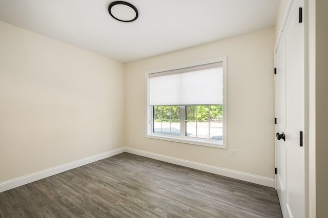 725 Central Ave Unit 103, Dover, NH 03820 - unfurnished room featuring dark wood-style flooring and baseboards
