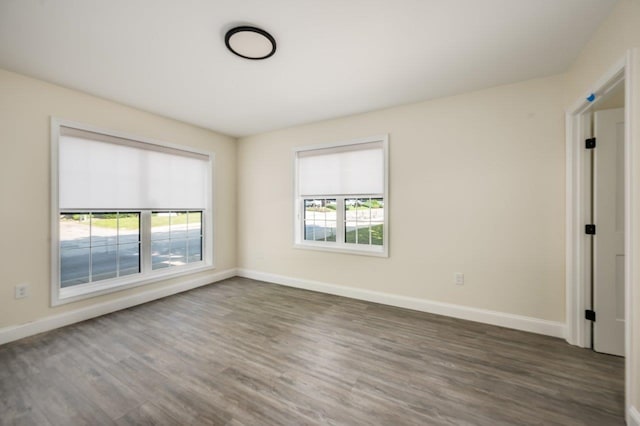 725 Central Ave Unit 103, Dover, NH 03820 - spare room featuring dark wood-style floors and baseboards