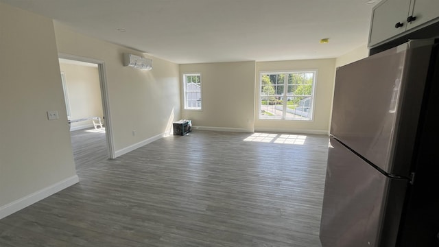 725 Central Ave Unit 103, Dover, NH 03820 - unfurnished living room featuring dark wood-style floors and a wall mounted AC