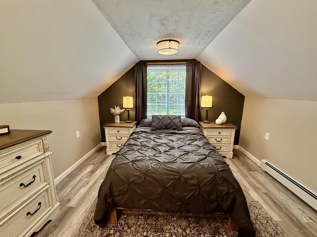 11 Francestown Rd, Bennington, NH 03442 - bedroom featuring a baseboard radiator, light wood finished floors, baseboards, lofted ceiling, and a textured ceiling