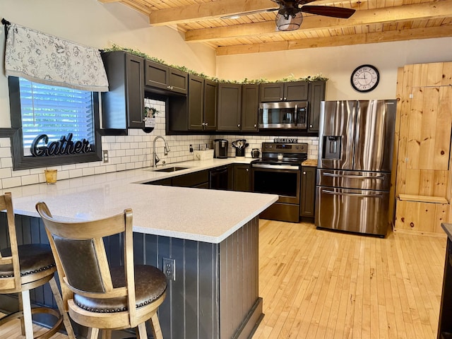 11 Francestown Rd, Bennington, NH 03442 - kitchen with appliances with stainless steel finishes, wooden ceiling with exposed beams, a sink, a peninsula, and light countertops