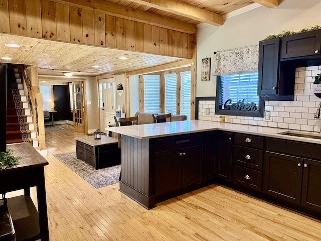 11 Francestown Rd, Bennington, NH 03442 - kitchen featuring wood ceiling with exposed beams, a sink, light countertops, tasteful backsplash, and light wood-type flooring