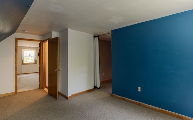353 N St, Jaffrey, NH 03452 - unfurnished bedroom featuring carpet floors, baseboards, and lofted ceiling
