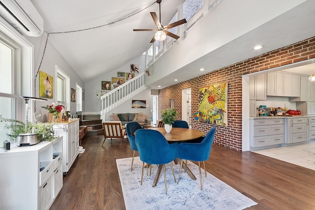 2 Candlewood Rd, Windham, NH 03087 - dining area featuring an AC wall unit, brick wall, a ceiling fan, wood finished floors, and stairs