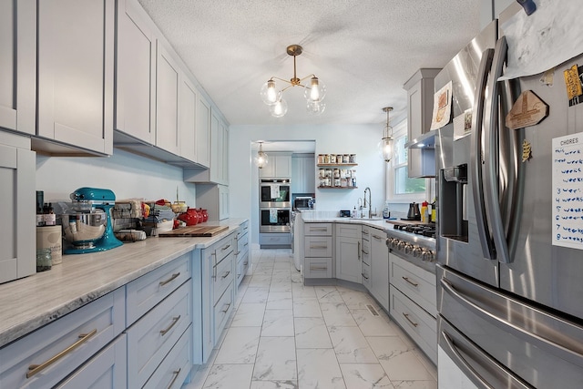 2 Candlewood Rd, Windham, NH 03087 - kitchen with stainless steel appliances, light marble finish floors, gray cabinetry, a sink, and open shelves