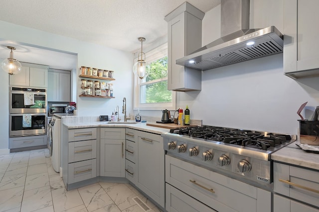 2 Candlewood Rd, Windham, NH 03087 - kitchen featuring wall chimney range hood, appliances with stainless steel finishes, gray cabinetry, a sink, and a textured ceiling