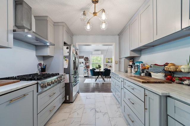 2 Candlewood Rd, Windham, NH 03087 - kitchen with wall chimney range hood, stainless steel appliances, light marble finish flooring, light countertops, and a chandelier