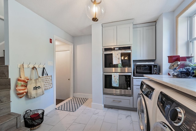 2 Candlewood Rd, Windham, NH 03087 - kitchen with appliances with stainless steel finishes, washing machine and clothes dryer, light marble finish floors, light countertops, and baseboards