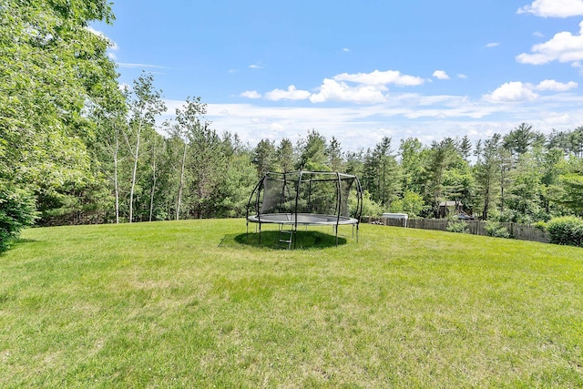 2 Candlewood Rd, Windham, NH 03087 - view of yard featuring a trampoline and a view of trees