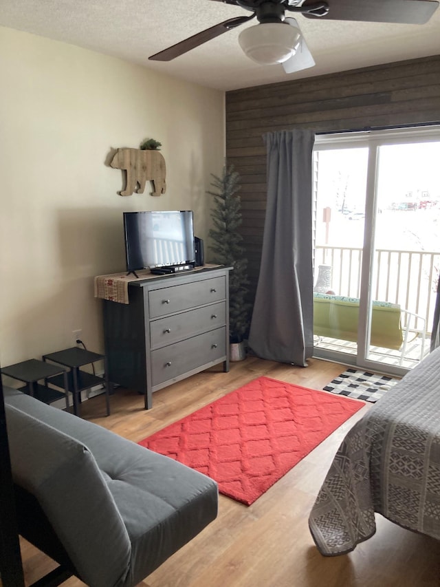 36 Lodge Rd Unit B105, Lincoln, NH 03251 - bedroom featuring access to exterior, wood finished floors, a ceiling fan, and a textured ceiling