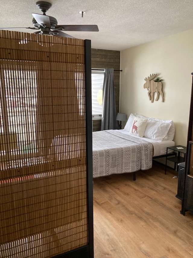 36 Lodge Rd Unit B105, Lincoln, NH 03251 - bedroom with light wood-type flooring, a textured ceiling, and ceiling fan