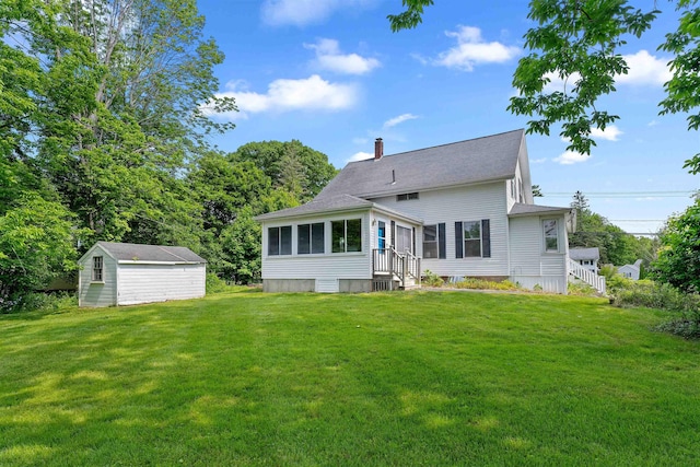 138 Sixth St, Dover, NH 03820 - rear view of property with a chimney, a lawn, a sunroom, and an outbuilding