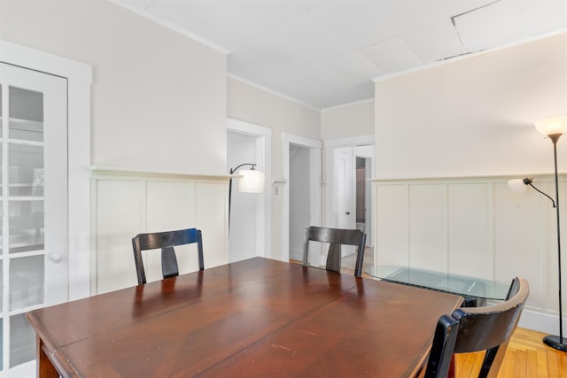 138 Sixth St, Dover, NH 03820 - dining space featuring a decorative wall, ornamental molding, wainscoting, and wood finished floors