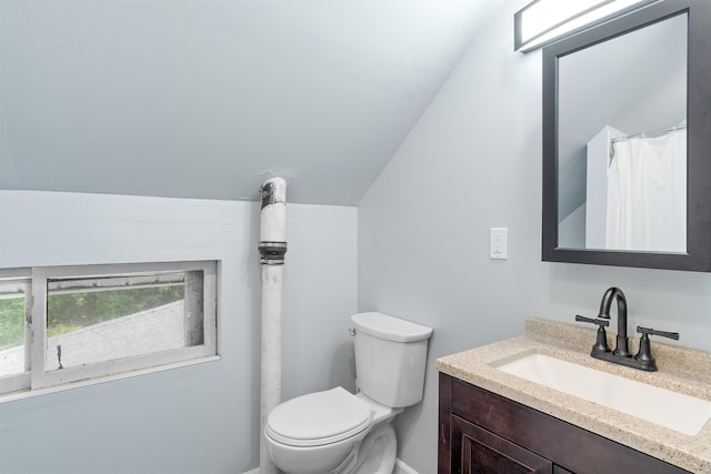 138 Sixth St, Dover, NH 03820 - bathroom with vanity, lofted ceiling, and toilet