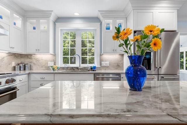 6 Tannery Way, Kensington, NH 03833 - kitchen with a sink, stainless steel appliances, white cabinetry, backsplash, and recessed lighting