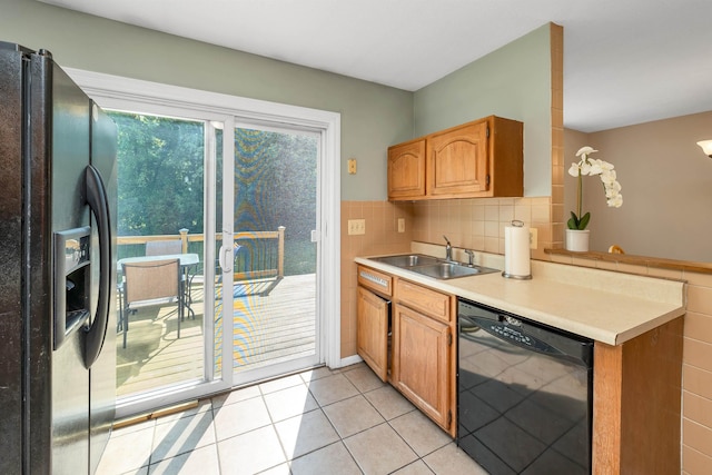 39 Orchard St, Laconia, NH 03246 - kitchen featuring black appliances, a sink, light countertops, light tile patterned flooring, and decorative backsplash