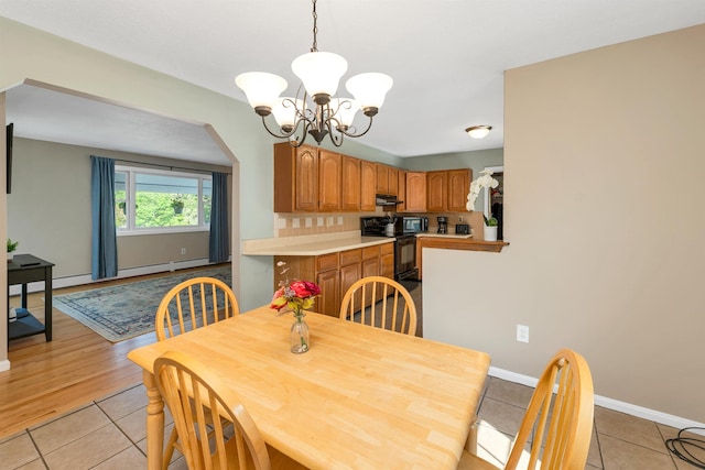 39 Orchard St, Laconia, NH 03246 - dining space featuring a chandelier, light tile patterned floors, baseboards, and a baseboard heating unit