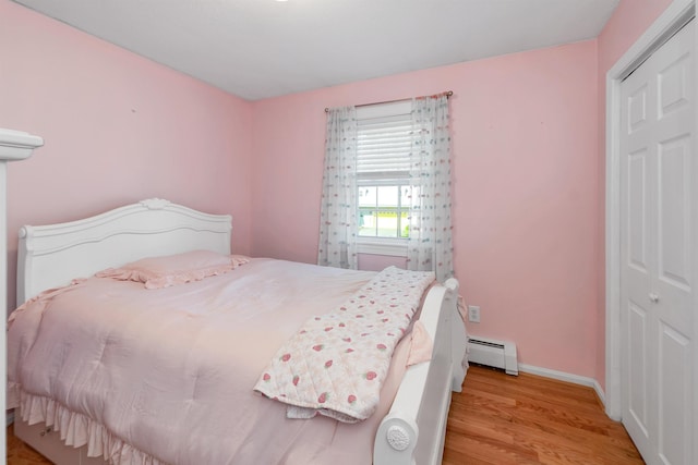 39 Orchard St, Laconia, NH 03246 - bedroom featuring wood finished floors, a baseboard heating unit, and baseboards