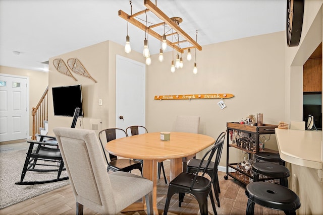 14 Monroe Dr Unit 92, Woodstock, NH 03293 - dining area featuring wood finished floors, stairway, and baseboards