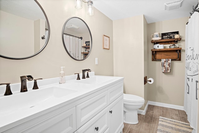 14 Monroe Dr Unit 92, Woodstock, NH 03293 - full bath with toilet, double vanity, wood tiled floors, and baseboards