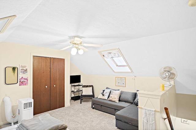 14 Monroe Dr Unit 92, Woodstock, NH 03293 - carpeted living area featuring vaulted ceiling, a skylight, and ceiling fan