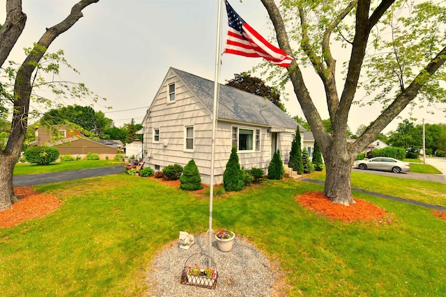 55 Harding St, Manchester, NH 03109 - view of side of home featuring a lawn and roof with shingles