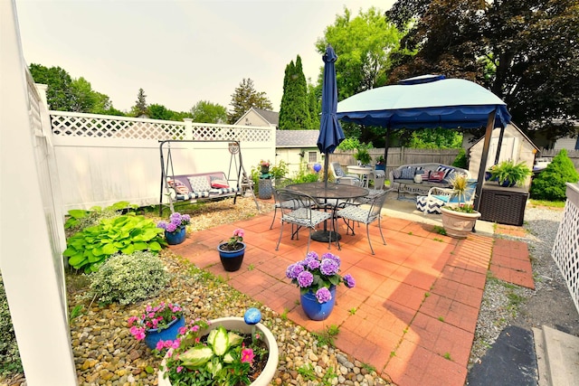 55 Harding St, Manchester, NH 03109 - fenced backyard with outdoor lounge area, a patio, and outdoor dining space