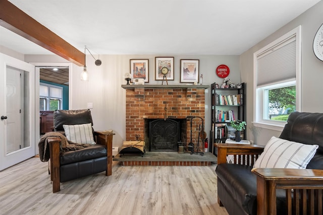 4 Franconia Dr, Nashua, NH 03063 - living room featuring light wood-style flooring, healthy amount of natural light, and a brick fireplace