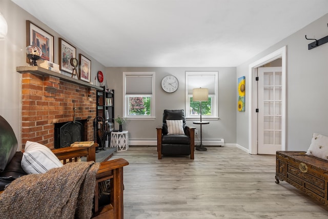4 Franconia Dr, Nashua, NH 03063 - living area featuring a baseboard radiator, baseboard heating, light wood finished floors, and a fireplace
