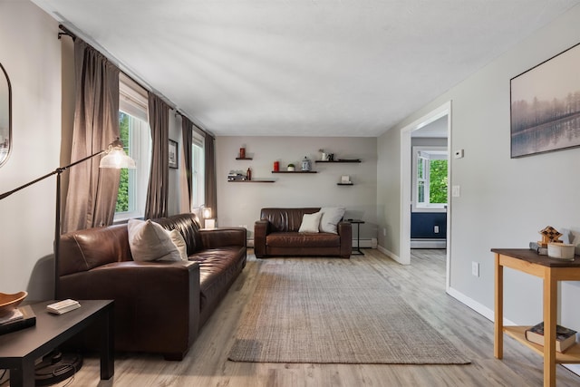 4 Franconia Dr, Nashua, NH 03063 - living room featuring baseboard heating, wood finished floors, a baseboard radiator, and baseboards