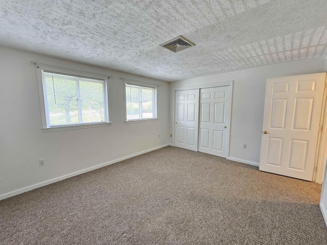 302 Eastview Dr, Wilton, NH 03086 - unfurnished bedroom featuring carpet, a textured ceiling, baseboards, and a closet
