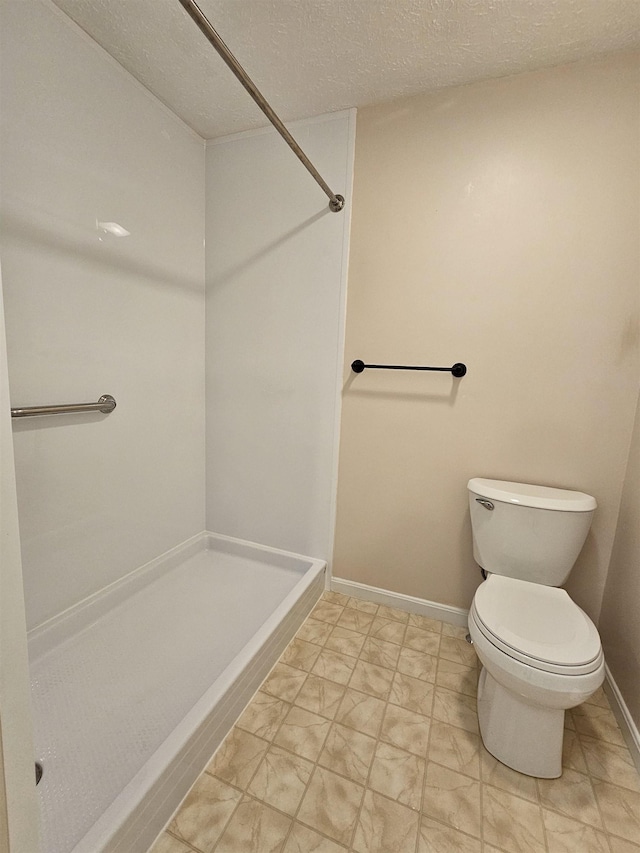 302 Eastview Dr, Wilton, NH 03086 - full bath featuring a stall shower, toilet, baseboards, and a textured ceiling