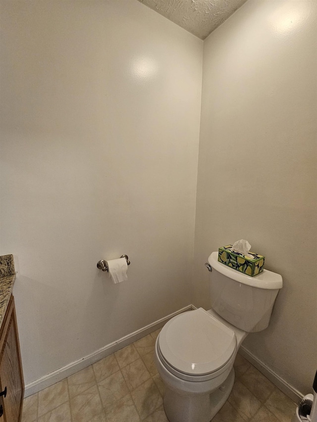 302 Eastview Dr, Wilton, NH 03086 - bathroom with toilet, vanity, a textured ceiling, and baseboards