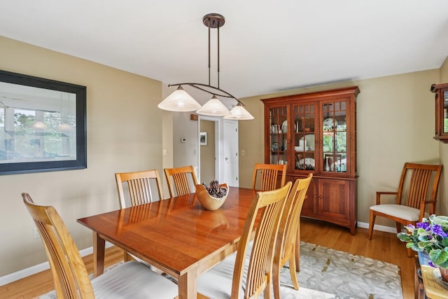 2 Warton Rd, Nashua, NH 03062 - dining room featuring light wood-style flooring and baseboards