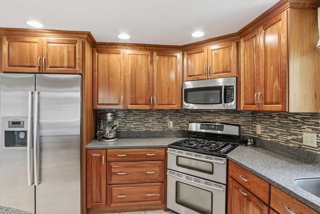 2 Warton Rd, Nashua, NH 03062 - kitchen featuring stainless steel appliances, dark countertops, brown cabinets, and tasteful backsplash