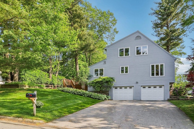 2 Warton Rd, Nashua, NH 03062 - view of side of property with an attached garage, asphalt driveway, and a lawn