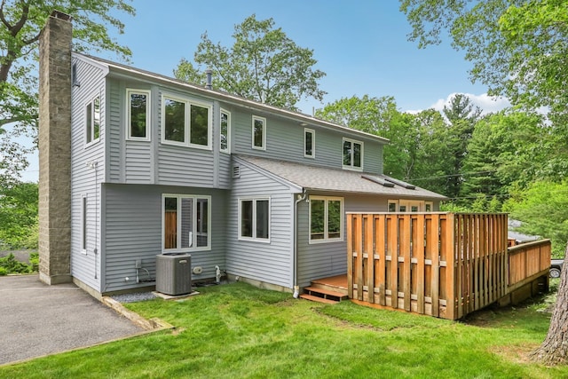 2 Warton Rd, Nashua, NH 03062 - back of property featuring central air condition unit, a lawn, a chimney, and a wooden deck