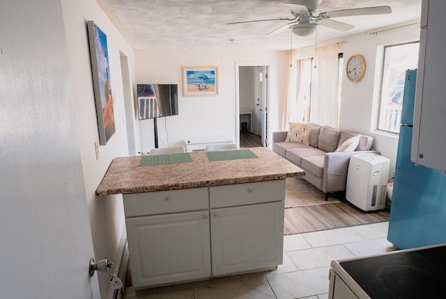 68 Kings Hwy Unit 30, Hampton, NH 03842 - kitchen featuring ceiling fan, a peninsula, open floor plan, light countertops, and white electric stove