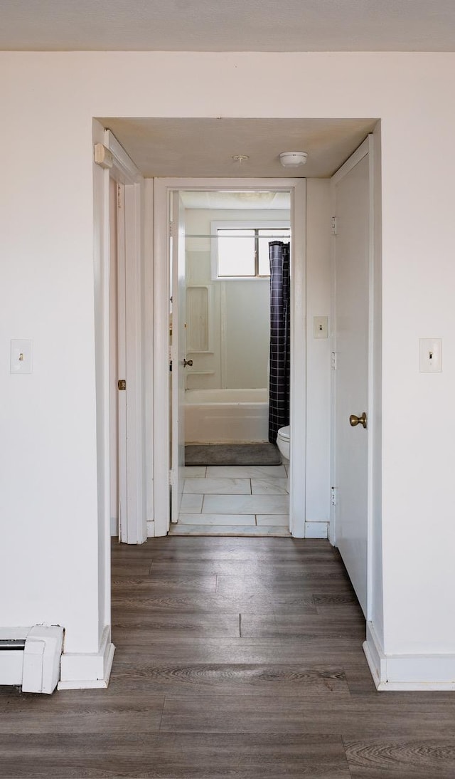 68 Kings Hwy Unit 30, Hampton, NH 03842 - hallway with wood finished floors, baseboards, and a baseboard heating unit