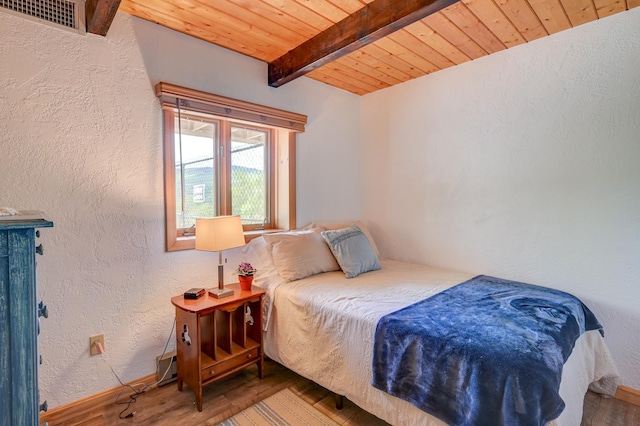 33 Karwendal Strasse, Bartlett, NH 03812 - bedroom featuring wooden ceiling with exposed beams, wood finished floors, a textured wall, and baseboards
