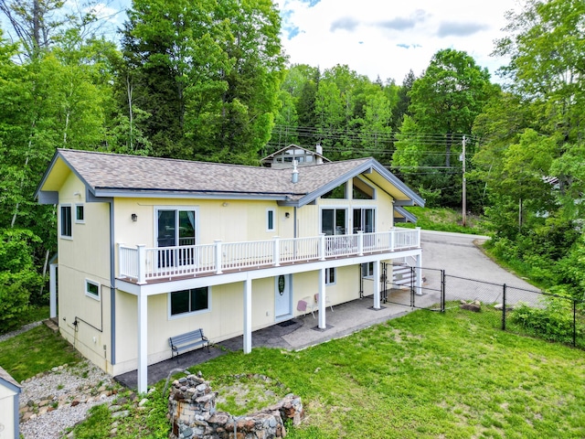 33 Karwendal Strasse, Bartlett, NH 03812 - rear view of house with roof with shingles, a wooden deck, a patio, and a forest view