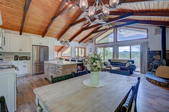 33 Karwendal Strasse, Bartlett, NH 03812 - dining room with wooden ceiling with exposed beams, high vaulted ceiling, a wood stove, dark wood finished floors, and a chandelier