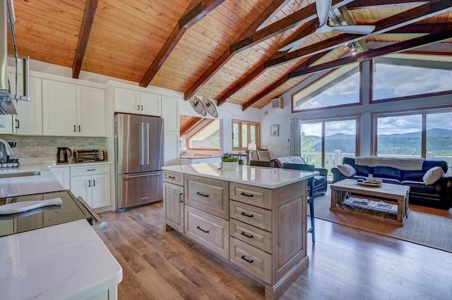 33 Karwendal Strasse, Bartlett, NH 03812 - kitchen featuring high end fridge, wood ceiling with exposed beams, light wood-style floors, a kitchen island, and high vaulted ceiling