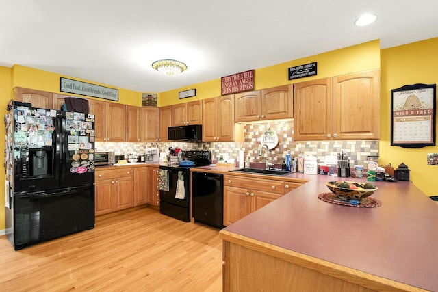 4 Mones Folly Dr, Dover, NH 03820 - kitchen featuring black appliances, a sink, light wood-type flooring, and tasteful backsplash