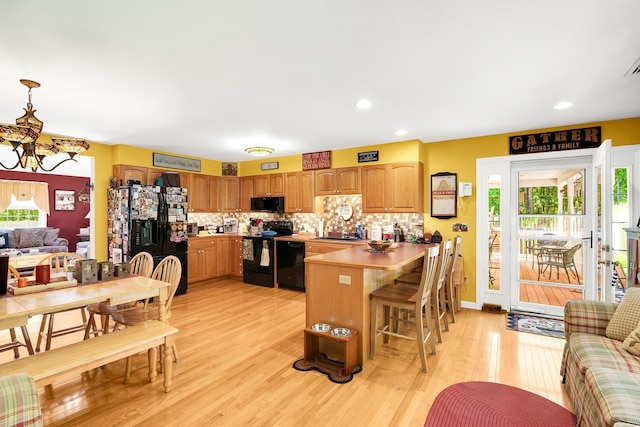 4 Mones Folly Dr, Dover, NH 03820 - kitchen with black appliances, a peninsula, light wood-type flooring, plenty of natural light, and recessed lighting