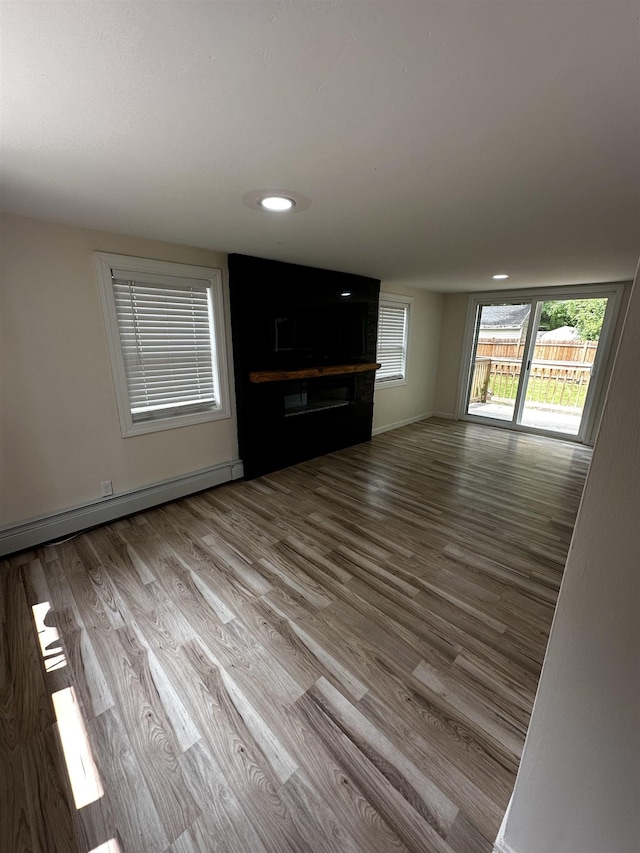 30 Flat Rock Bridge Rd, Rochester, NH 03868 - unfurnished living room with a baseboard radiator, wood finished floors, baseboards, and recessed lighting