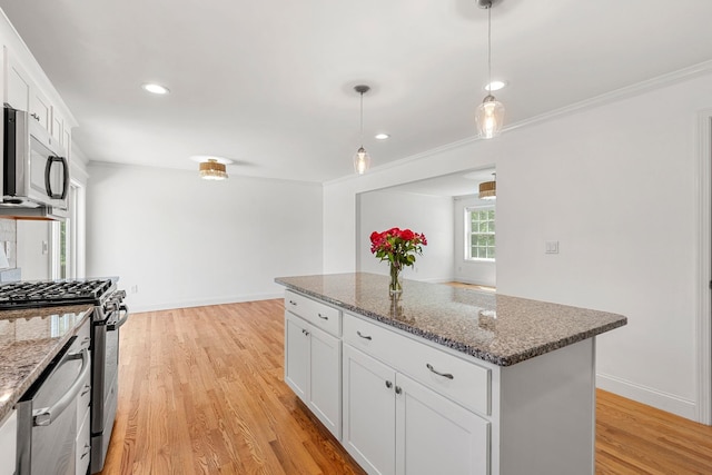 250 Harmony Rd, Northwood, NH 03261 - kitchen with stainless steel appliances, light wood finished floors, a kitchen island, white cabinets, and dark stone countertops